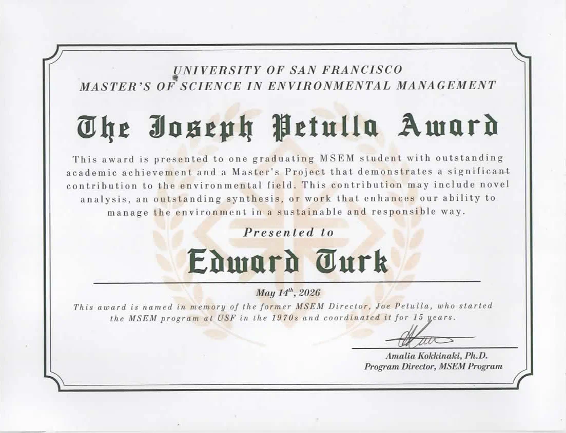 Certificate headed University of San Francisco, Master's of Science in Environmental Management, titled The Joseph Petulla Award in blackletter type over a faint laurel watermark. The text reads that the award is presented to one graduating MSEM student with outstanding academic achievement and a Master's Project that demonstrates a significant contribution to the environmental field. Presented to Edward Turk, May 14th, 2026, signed by Amalia Kokkinaki, Ph.D., Program Director, MSEM Program.
